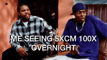 ice cube and a man in a blue shirt are sitting next to each other in front of a door ..