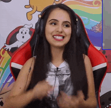 a woman wearing headphones sits in a red chair in front of a cartoon background