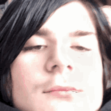 a close up of a woman 's face with her eyes closed and her mouth open