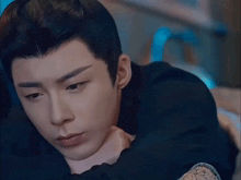 a close up of a man laying down with his eyes closed