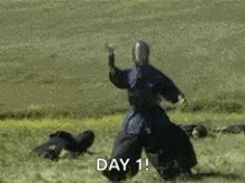 a scarecrow is standing in the middle of a field with smoke coming out of his hands .