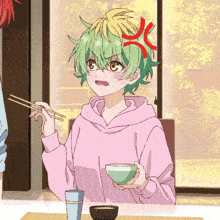 a girl with green hair is sitting at a table eating with chopsticks