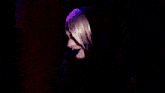 two drag queens are standing next to each other on a stage in front of a crowd .