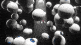 a bunch of balls are floating in the air in a dark room .