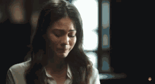 a woman is crying with a bandage on her face .