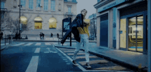 a man is walking down a street in front of a building that says bnp paribas