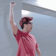 a man with red hair and glasses is wearing a red t-shirt that says mp on it