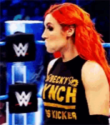 a woman with red hair is wearing a black shirt that says ' becky lynch ' on it
