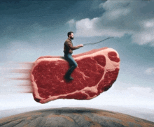 a man is riding a large piece of meat in the sky