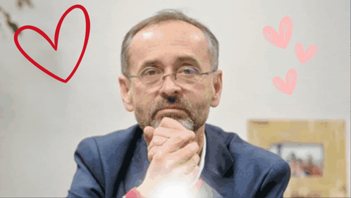 a man with a beard and glasses is surrounded by hearts