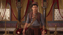 a man in a fancy costume is sitting in a chair