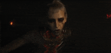 a close up of a person 's face with blood on it