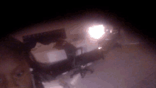 a blurry picture of a bedroom with a bed and chairs