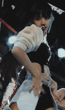 a woman with a microphone in her mouth dancing