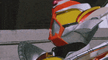 a close up of a robot 's head with a red eye