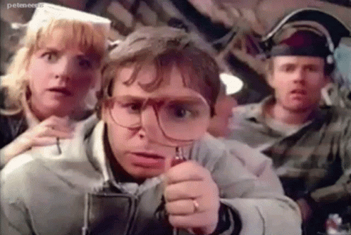 Rick moranis with a magnifying glass
