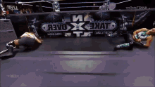 two women wrestling in front of a banner that says revo x hat