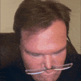 a man wearing glasses has a nose ring in his nose