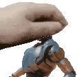a person is holding a toy robot on their finger .