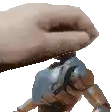a person is holding a toy robot on their finger .