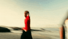 a blurry picture of a man in a red sweater