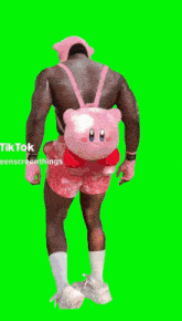 a shirtless man is wearing a pink hat and pink shorts .
