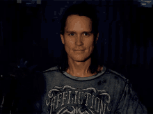 a man wearing a shirt that says affliction