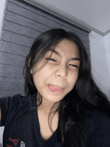 a girl making a funny face with her tongue out