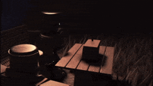 a dark room with a wooden table in the middle of it