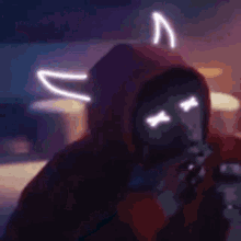 a person in a red hoodie with neon horns is holding a gun .