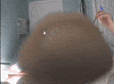 a blurred image of a person 's head with a arrow pointing to the right