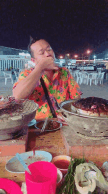 a man sitting at a table with plates of food on it