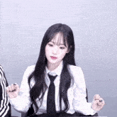 a girl wearing a white shirt and black tie