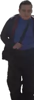 a man in a blue turtleneck and black pants is walking
