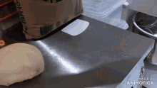 a bag of flour sits on top of a stainless steel counter