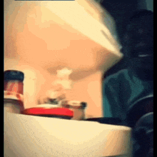 a blurry picture of a person standing in front of a refrigerator
