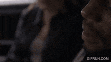 a man with a beard is talking on a cell phone in a car .