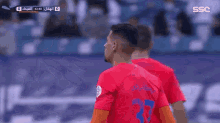 a soccer player wearing a red and blue jersey with the number 37 on it