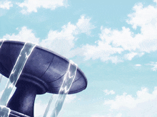 a fountain with water coming out of it against a blue sky with clouds