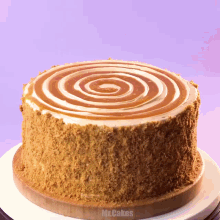 a cake with a caramel swirl on top of it and the words mr.cakes behind it