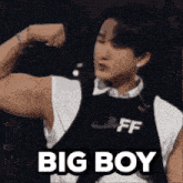 a man is flexing his muscles and the words big boy are on the bottom