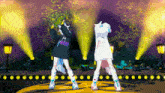 two anime girls are dancing on a stage and one of them has a hoodie that says ' tokyo ' on the back