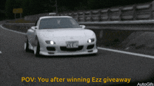 a white sports car is driving down a highway with the caption " you after winning ezz giveaway "