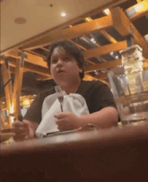 a man is sitting at a table holding a fork