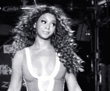 a black and white photo of a woman with long curly hair