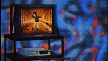 a tamari television is on a stand next to a vcr
