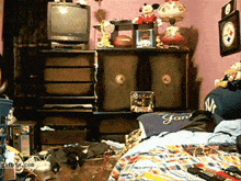 a messy bedroom with a tv and a yankees shirt