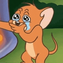 jerry from tom and jerry is crying while holding a stick .