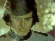a close up of a man 's face with a blurry background