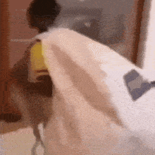 a person is laying on a bed with a white blanket